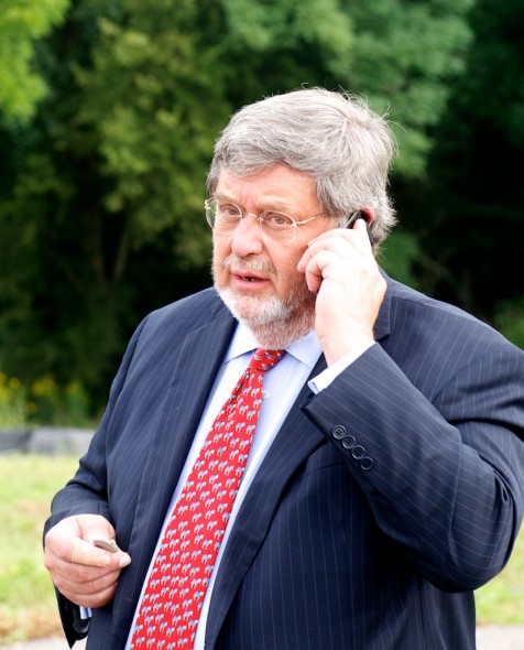 Diageo executive vice president Guy Smith talks on the phone prior to the groundbreaking's press conference.