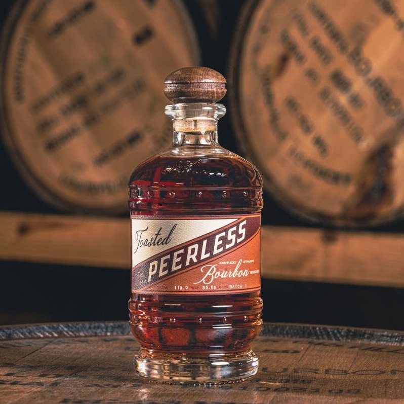 Peerless Toasted Bourbon bottle on barrels
