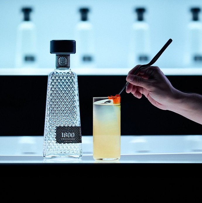 1800 Tequila Cristalino with cocktail on bar