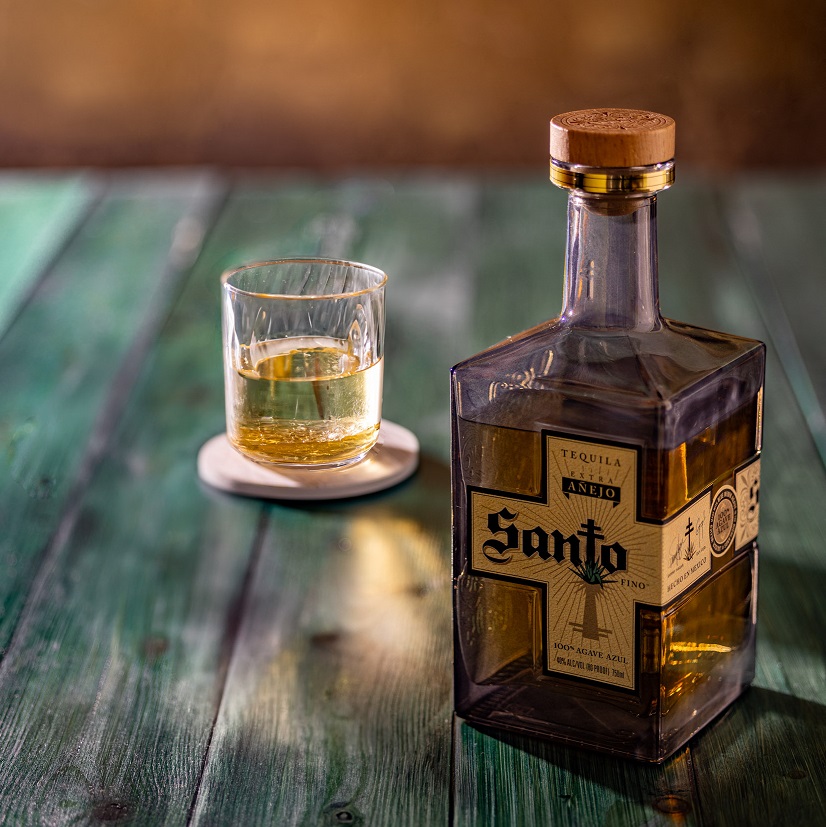Santo Tequila Extra Anejo Lifestyle bottle with pour