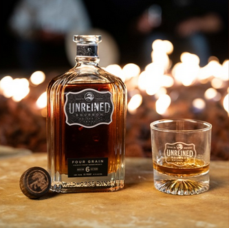 Unreined Whiskey Official Whiskey Of Texas A&M Athletics bottle and glass