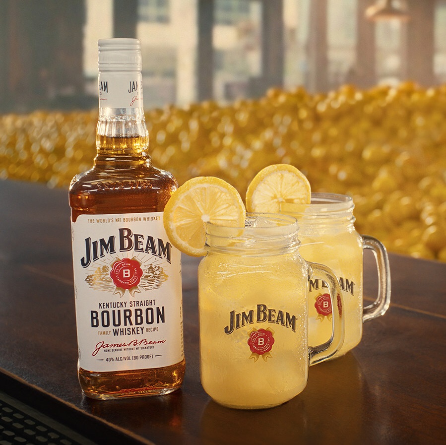 Jim Beam Season Refresh bottle with cocktails and lemons