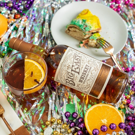 Big Easy Whiskey Cocktail, bottle and King Cake with beads