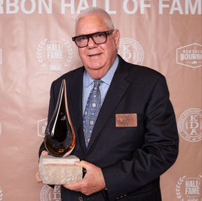 Corky Taylor holding Bourbon Hall of Fame trophy