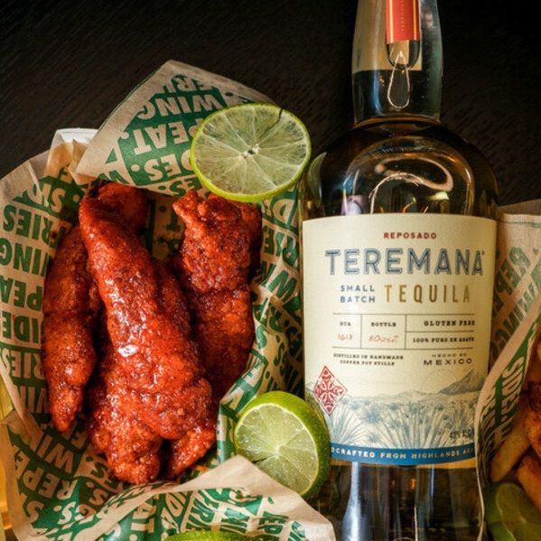 Teremana Tequila bottle and Wingstop chicken tenders