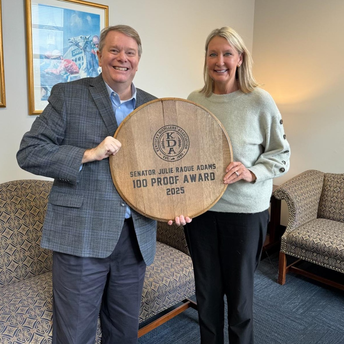 Eric Gregory and Julie Raque Adams with plaque