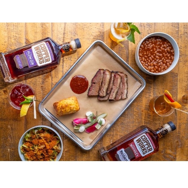 Copperworks Distilling BBQ with whiskey bottles