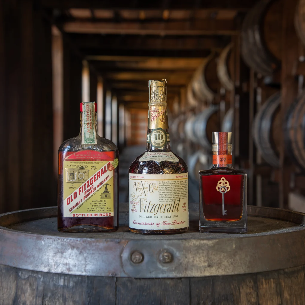 Old Fitzgerald three vintage bottles on barrel