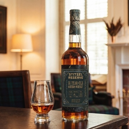 Stitzel Reserve 31-Year-Old Bourbon b0ottle with glass on table