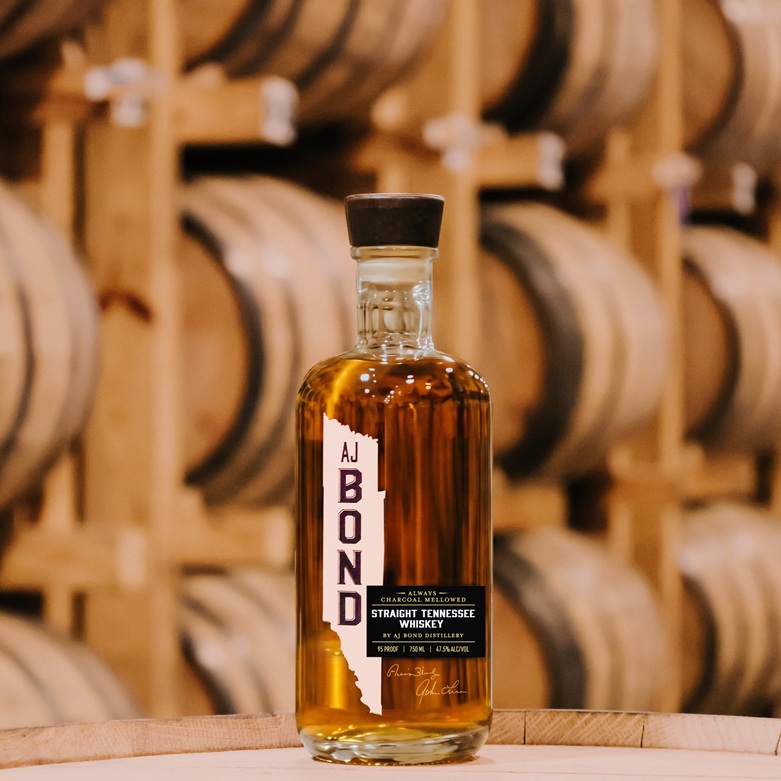AJ Bond Tennessee Whiskey bottle in rickhouse