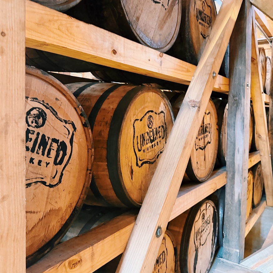 Unreined Whiskey barrels in rickhouse