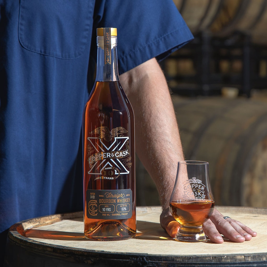 COPPER & CASK X bottle on barrel